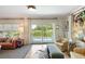 Bright living room with a sliding glass door that opens to the pool, a sofa, and stylish decor at 2 Pierates Cruz, Mount Pleasant, SC 29464