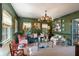 Stylish living room with green walls, designer furniture, and artistic accents at 2 Pierates Cruz, Mount Pleasant, SC 29464