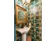 Unique powder room featuring colorful wallpaper and a stylish pedestal sink at 2 Pierates Cruz, Mount Pleasant, SC 29464