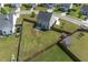 Aerial view showcases the large, fenced backyard, with storage sheds and lush green lawn at 2113 Pimlico Dr, Ridgeville, SC 29472