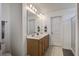 Bathroom boasts double sinks, a large mirror with vanity lighting, and a door to the shower at 2113 Pimlico Dr, Ridgeville, SC 29472