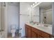 Bathroom featuring a double sink vanity with wood cabinets, a large mirror, and a toilet at 2113 Pimlico Dr, Ridgeville, SC 29472