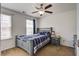 Bedroom with a ceiling fan, a window with curtains, a bed with blue accents, and a nightstand at 2113 Pimlico Dr, Ridgeville, SC 29472