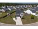 Aerial view of a two-story house with a well-manicured lawn and tree lined street at 2113 Pimlico Dr, Ridgeville, SC 29472