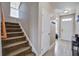 View of a hallway with stairs, a coat closet, a front door with sidelights, and light wood-look floors at 2113 Pimlico Dr, Ridgeville, SC 29472