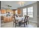 Eat-in kitchen with a dining table and chairs, adjacent to the kitchen featuring updated appliances and wood cabinets at 2113 Pimlico Dr, Ridgeville, SC 29472