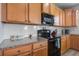 Close-up of the kitchen with granite countertops, subway tile backsplash, stainless steel appliances, and wood cabinets at 2113 Pimlico Dr, Ridgeville, SC 29472