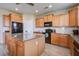 Bright kitchen featuring an island, updated appliances, granite countertops, and light wood cabinets at 2113 Pimlico Dr, Ridgeville, SC 29472