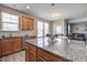 Kitchen features an island, granite countertops, stainless steel appliances, and ample cabinet space at 2113 Pimlico Dr, Ridgeville, SC 29472