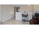 Open living space with modern wood-look tile flooring, a TV, and a safety gate at 2113 Pimlico Dr, Ridgeville, SC 29472