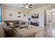 Living room featuring an entertainment center, plush sofa, area rug, and abundant natural light at 2113 Pimlico Dr, Ridgeville, SC 29472