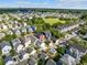 An aerial view of a charming neighborhood showcasing a red home near community green space at 218 Barberry St, Summerville, SC 29483