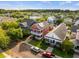 An aerial view of a charming red two-story home with solar panels and a well-manicured front lawn at 218 Barberry St, Summerville, SC 29483