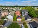 A serene neighborhood featuring a charming red two-story home with lush lawns and cozy detached garages at 218 Barberry St, Summerville, SC 29483