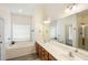 Bright bathroom featuring a double vanity, soaking tub, and a separate shower at 218 Barberry St, Summerville, SC 29483