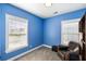 Cozy bedroom with blue walls, plush carpet, large windows, and leather chair at 218 Barberry St, Summerville, SC 29483