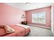 Bedroom features pink walls, a plush carpet, a bed and a desk by the window at 218 Barberry St, Summerville, SC 29483