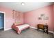 Bedroom features pink walls, a plush carpet, a bed and a desk by the window at 218 Barberry St, Summerville, SC 29483