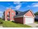 Charming two-story home with a detached garage and a well-manicured lawn under a bright, partly cloudy sky at 218 Barberry St, Summerville, SC 29483