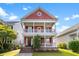 Charming two-story home with double porches, a red facade, a black front door and manicured front lawn at 218 Barberry St, Summerville, SC 29483