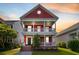 Charming two-story home with double porches and a red facade, set against a colorful sunset sky at 218 Barberry St, Summerville, SC 29483