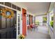 Inviting front porch with a colorful wreath and cozy seating area at 218 Barberry St, Summerville, SC 29483