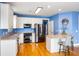 Well-lit kitchen features white cabinets, stainless steel appliances, and an adjacent breakfast bar at 218 Barberry St, Summerville, SC 29483