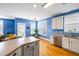 Open kitchen with stainless appliances, an island, and hardwood floors that connect to the living area at 218 Barberry St, Summerville, SC 29483
