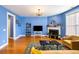 Bright living room with fireplace, hardwood floors, area rug, and blue walls at 218 Barberry St, Summerville, SC 29483