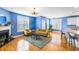 Well-lit living room featuring hardwood floors, stylish furnishings, a blue accent wall, and an open layout at 218 Barberry St, Summerville, SC 29483