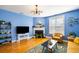 Bright living room features a fireplace, blue walls, hardwood floors and modern fixtures at 218 Barberry St, Summerville, SC 29483