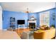 Bright living room features blue walls, hardwood floors, a fireplace, and stylish contemporary furnishings at 218 Barberry St, Summerville, SC 29483