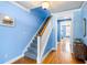 Carpeted staircase with natural wood railings leading to the upper level of the home at 218 Barberry St, Summerville, SC 29483