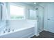 Bright bathroom featuring a shower and a tub by the window at 222 Torslanda Ln, Summerville, SC 29486
