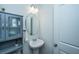 Clean half bath featuring a pedestal sink, gray vanity, and modern lighting at 222 Torslanda Ln, Summerville, SC 29486
