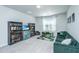 Bright bonus room with carpet, a green sofa, and lots of storage shelves at 222 Torslanda Ln, Summerville, SC 29486