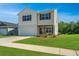 Charming two-story home featuring a manicured lawn, attached garage, and classic curb appeal with vinyl siding at 222 Torslanda Ln, Summerville, SC 29486