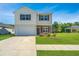 Inviting two-story home with a well-kept lawn, attached garage, and a charming outdoor gazebo visible in the background at 222 Torslanda Ln, Summerville, SC 29486