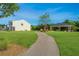 Well-maintained home exterior with a sidewalk leading to a community gazebo at 222 Torslanda Ln, Summerville, SC 29486