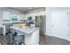 Modern kitchen featuring granite countertops, stainless steel appliances, a kitchen island with seating, and white cabinetry at 222 Torslanda Ln, Summerville, SC 29486
