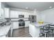 Well-equipped kitchen with stainless steel appliances, granite countertops, a central island, and ample white cabinetry at 222 Torslanda Ln, Summerville, SC 29486