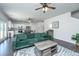 Open-concept living room with a green sofa, ceiling fans, and view to the kitchen at 222 Torslanda Ln, Summerville, SC 29486