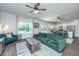 Living room featuring a green sofa, blue chair, and open access to kitchen at 222 Torslanda Ln, Summerville, SC 29486