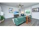 Cozy living room with green sofa, beach-themed TV, and hardwood floors at 222 Torslanda Ln, Summerville, SC 29486