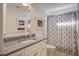 Charming bathroom featuring blue tile countertops, framed art, and a patterned shower curtain at 229 Gordon St, Charleston, SC 29403