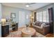 A functional bedroom provides a desk area, sofa and a soft rug with a neutral color scheme at 229 Gordon St, Charleston, SC 29403