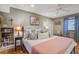 Calm bedroom with a ceiling fan, full bed, bookshelves and window seating at 229 Gordon St, Charleston, SC 29403