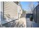The side of the home features a concrete walkway, painted siding, and a dark wooden fence at 229 Gordon St, Charleston, SC 29403
