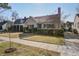 Inviting two-story home with a brick chimney and lush landscaping, situated on a well-maintained lot at 229 Gordon St, Charleston, SC 29403