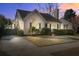 Inviting home with a brick facade, trimmed hedges, and a driveway leading to a detached garage at 229 Gordon St, Charleston, SC 29403